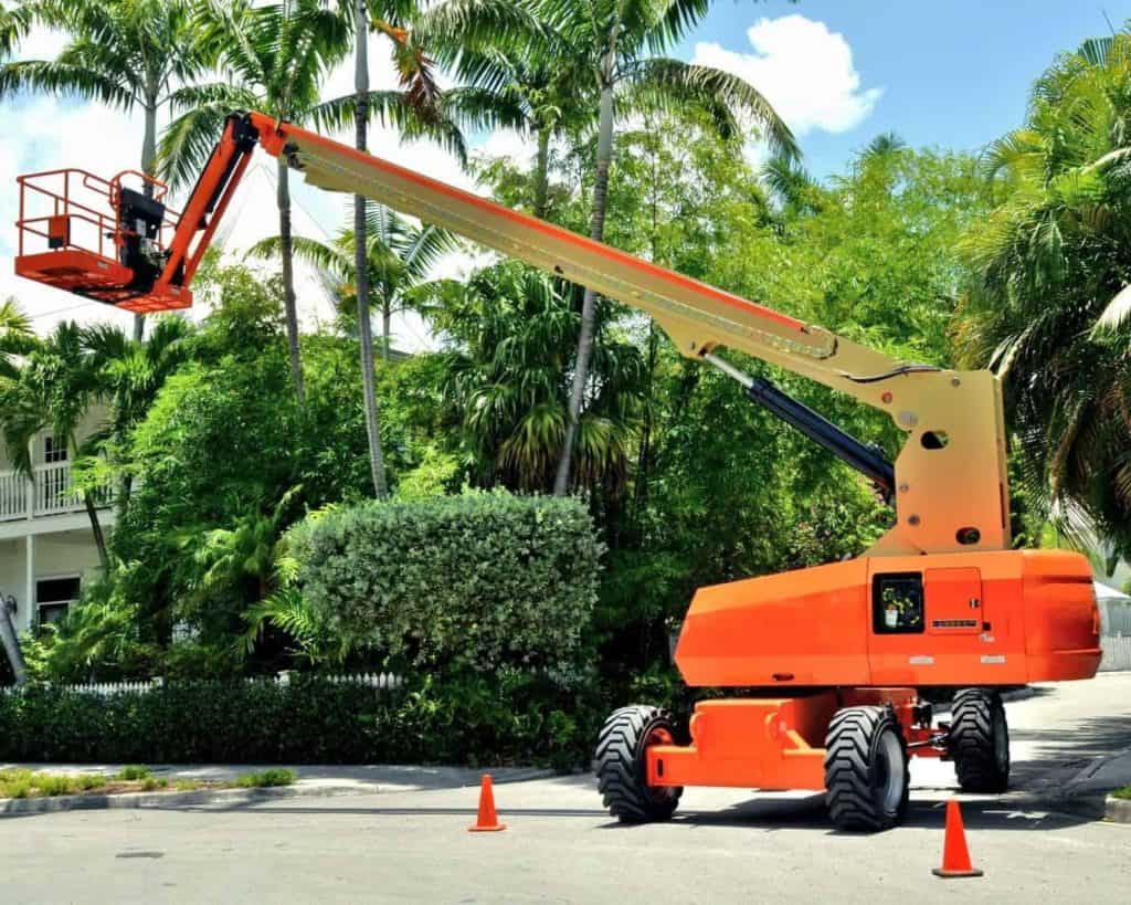 a large orange crane sitting on top of a street.